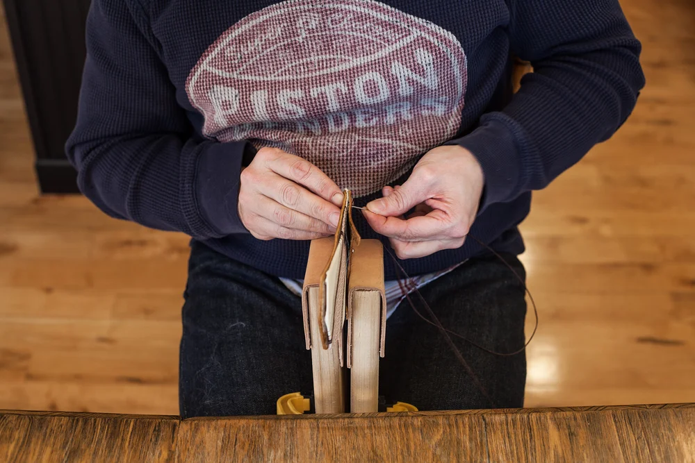 Hand sewing in a stitching pony