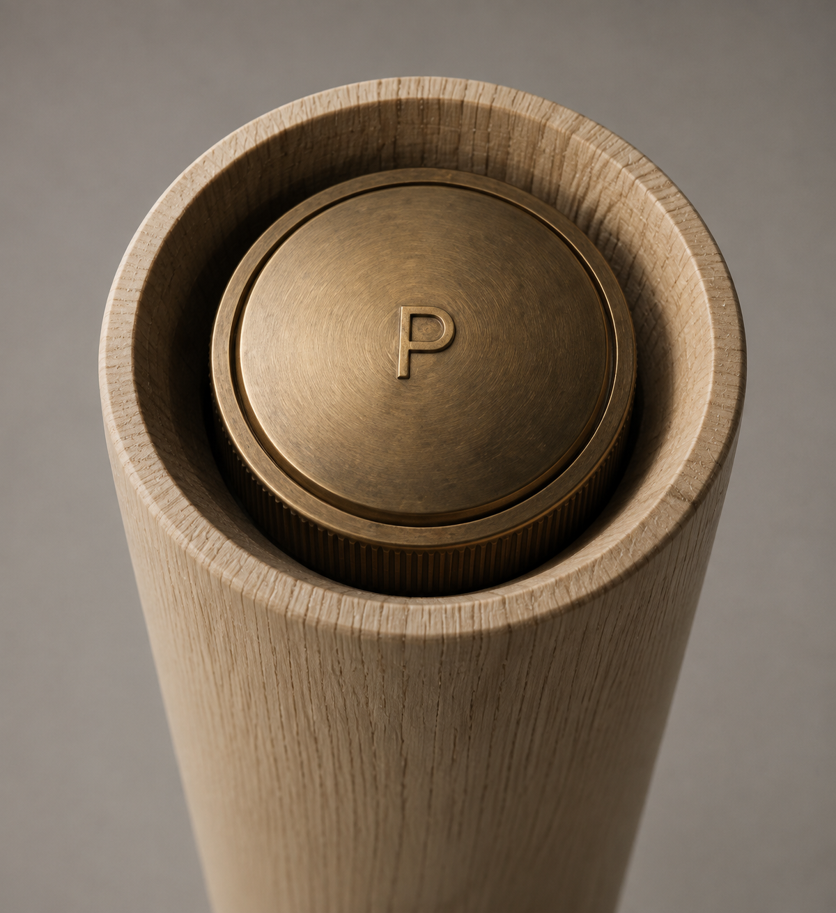 The brushed brass cap, struck with a P